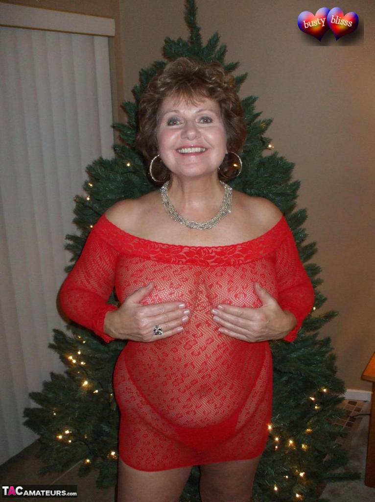 Mature lady Busty Bliss exposes her breasts during a Christmas celebration porn photo #422972956