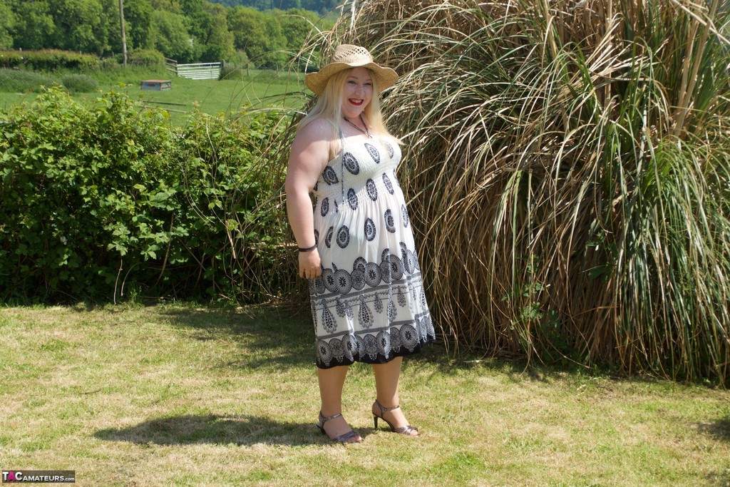 Blonde BBW makes her nude debut in a yard while wearing a hat and tan hosiery porn photo #425487474