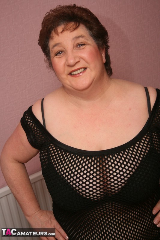 Thick Older Woman Kinky Carol Sports Short Hair While Modelling A Mesh Dress