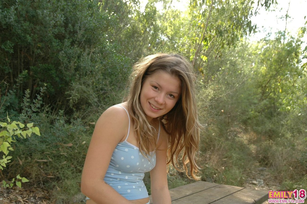 Charming young girl uncovers her tiny tits on a picnic table at a park foto porno #427507924
