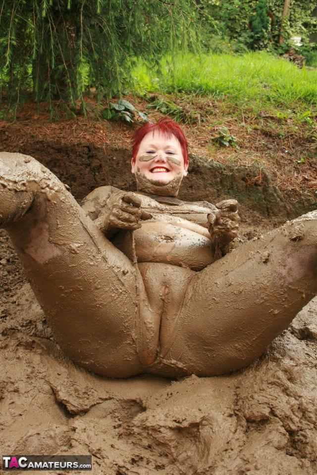 Older Redhead Valgasmic Exposed Rolls Around In A Mud Pit While Totally Naked