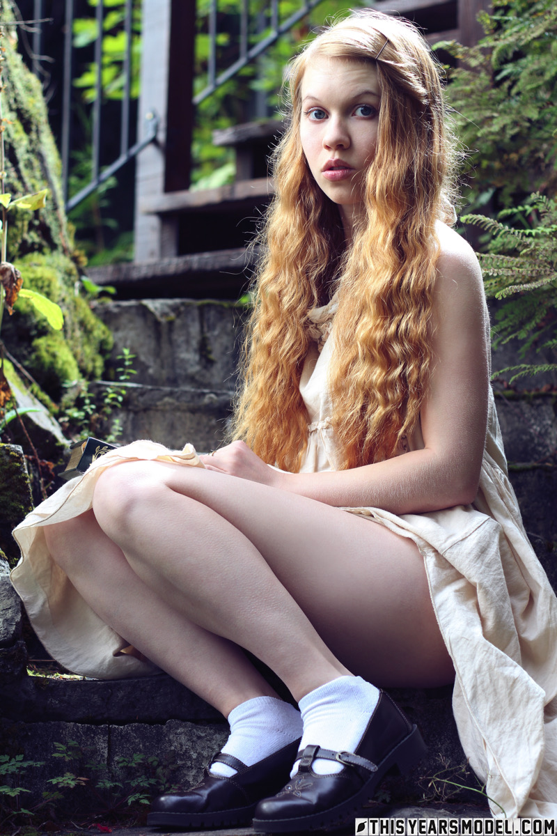 Young redhead Dolly Little exposes herself on garden steps while reading porno foto #426600140