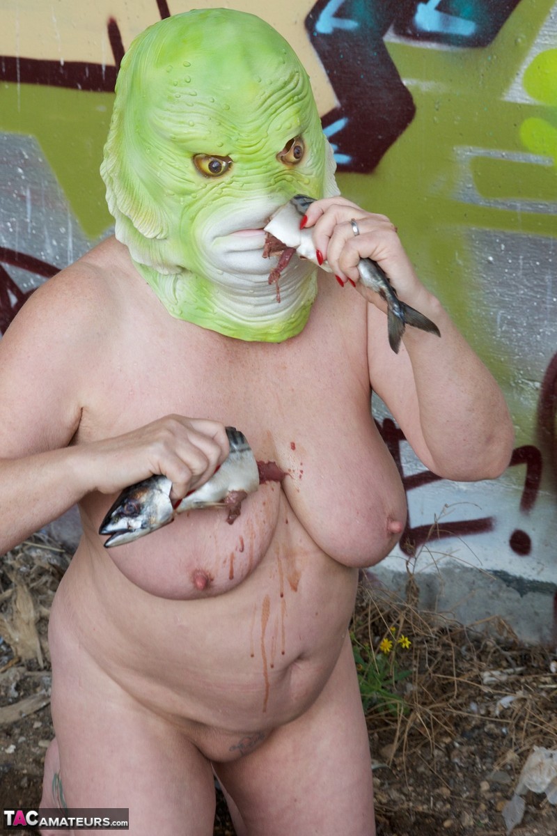 Naked British lady Speedy Bee eats a fish while wearing a costume mask porn photo #426468058