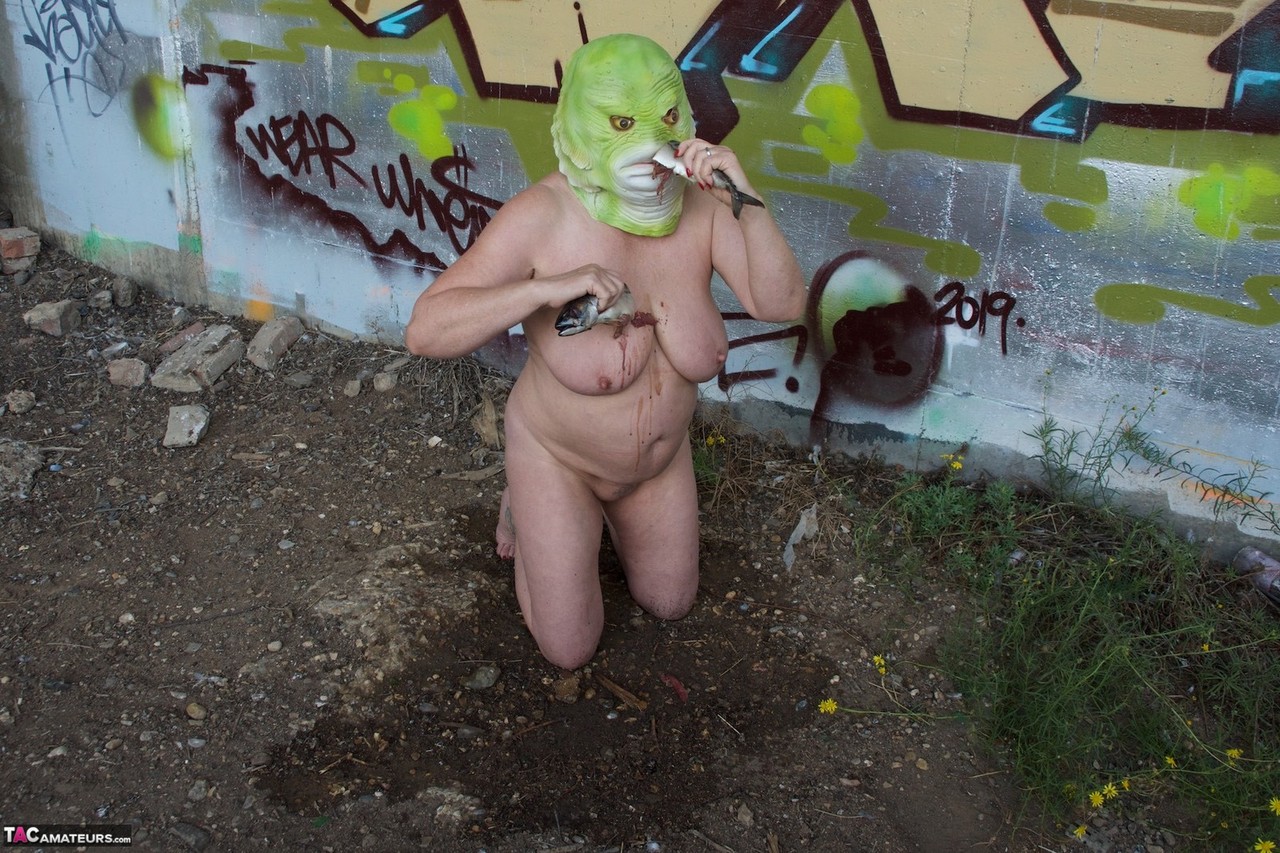 Naked British lady Speedy Bee eats a fish while wearing a costume mask porn photo #426468064