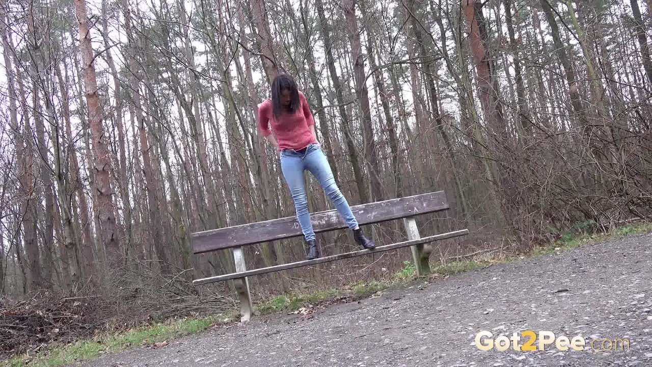 Tiny Tina squats on a wooden bench alongside a path for an urgent piss foto porno #425406122