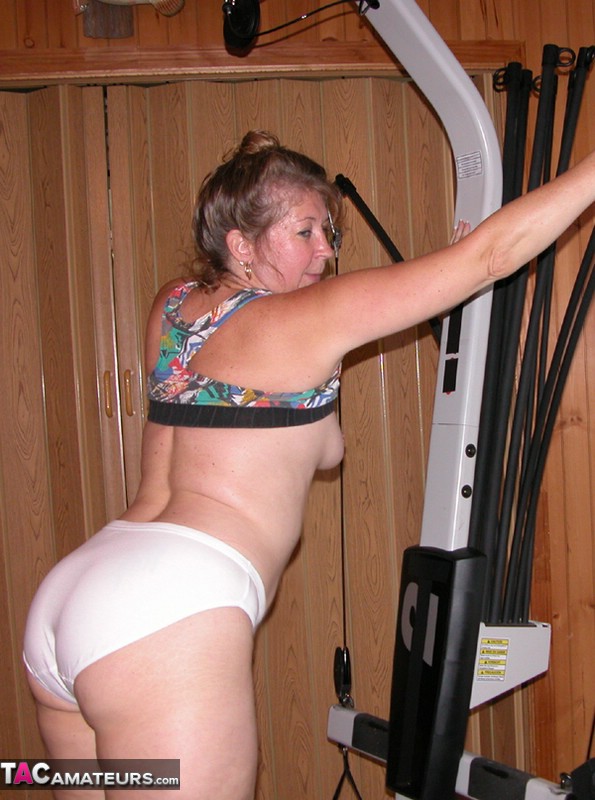 Mature amateur Devlynn exposes her tits and snatch on home gym equipment porn photo #424675925