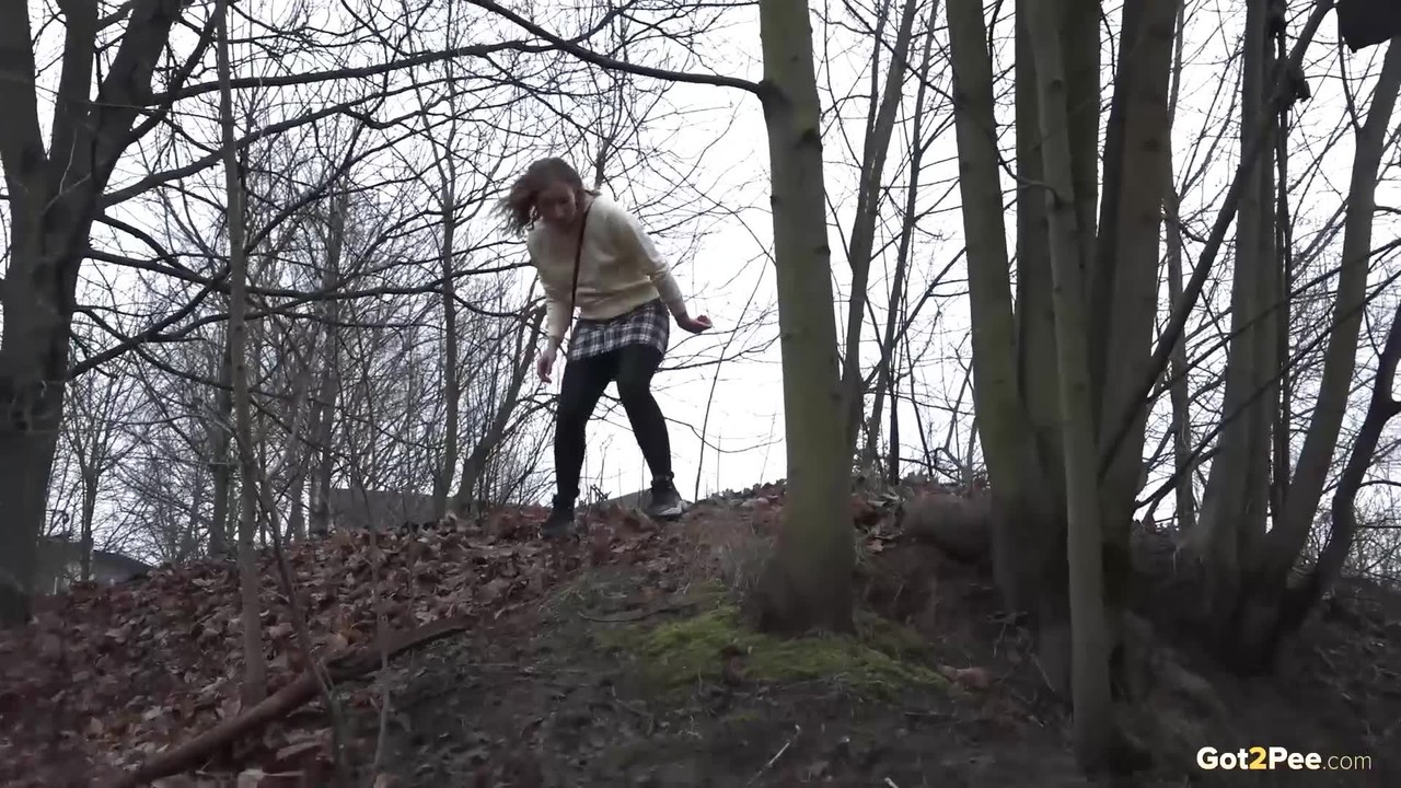 Caucasian girl takes a piss in an outhouse while in a forest foto porno #426309954