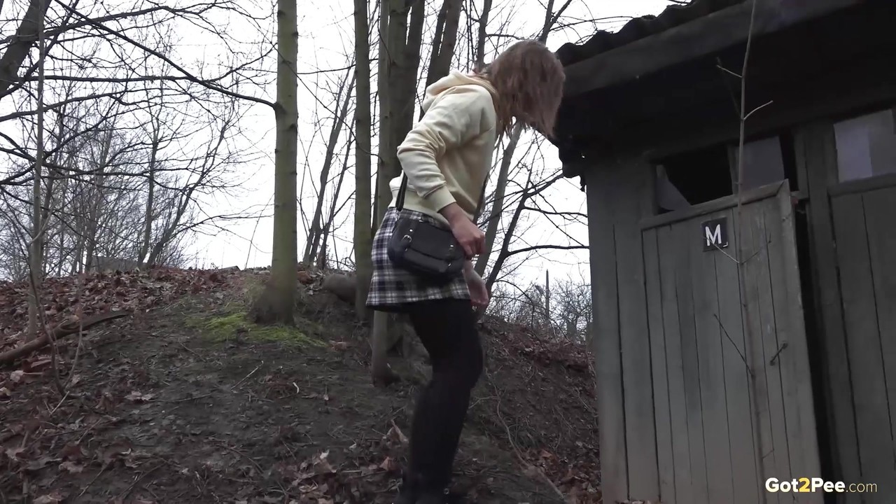 Caucasian girl takes a piss in an outhouse while in a forest porno fotoğrafı #425533481