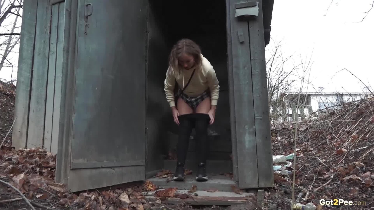 Caucasian girl takes a piss in an outhouse while in a forest porno fotoğrafı #426309964