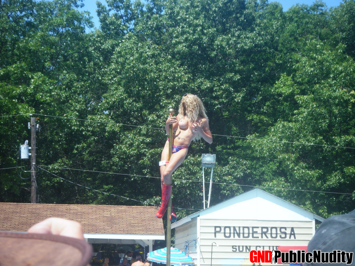 Naked strippers decorate the stage during an outdoor festival photo porno #426426528