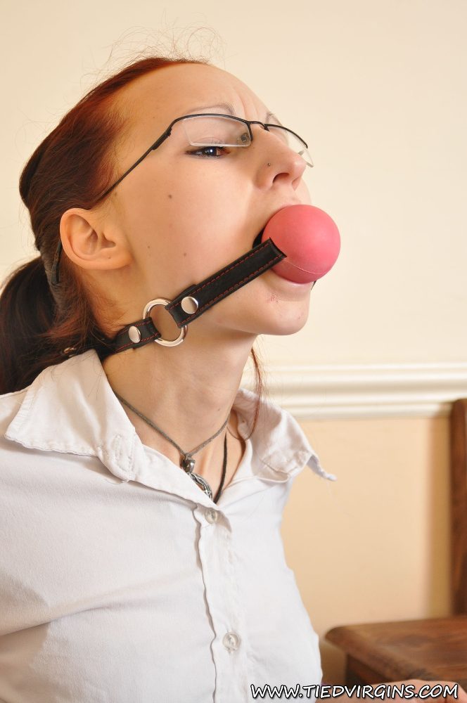 Geeky redhead sports a big ball gag while restrained in chains porn photo #427898580