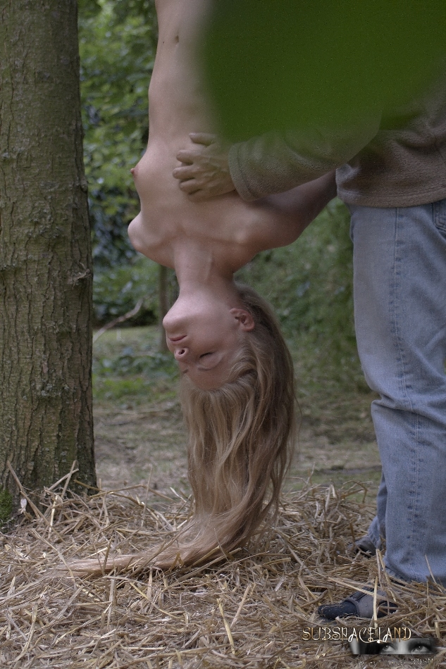 Young blonde girl has her hair pull after being suspended upside down in woods porn photo #422611528