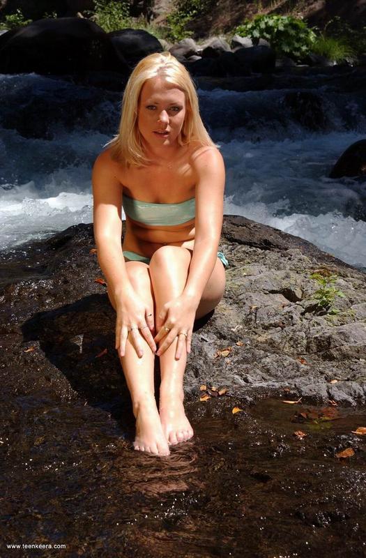 Young blonde removes her bikini to pet her twat on slippery rocks foto porno #426349882