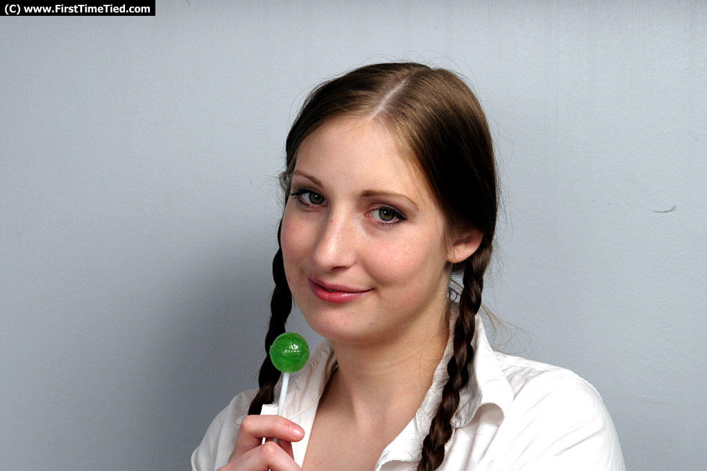 Schoolgirl with braided pigtails licks a sucker after escaping rope bonds foto porno #425367074