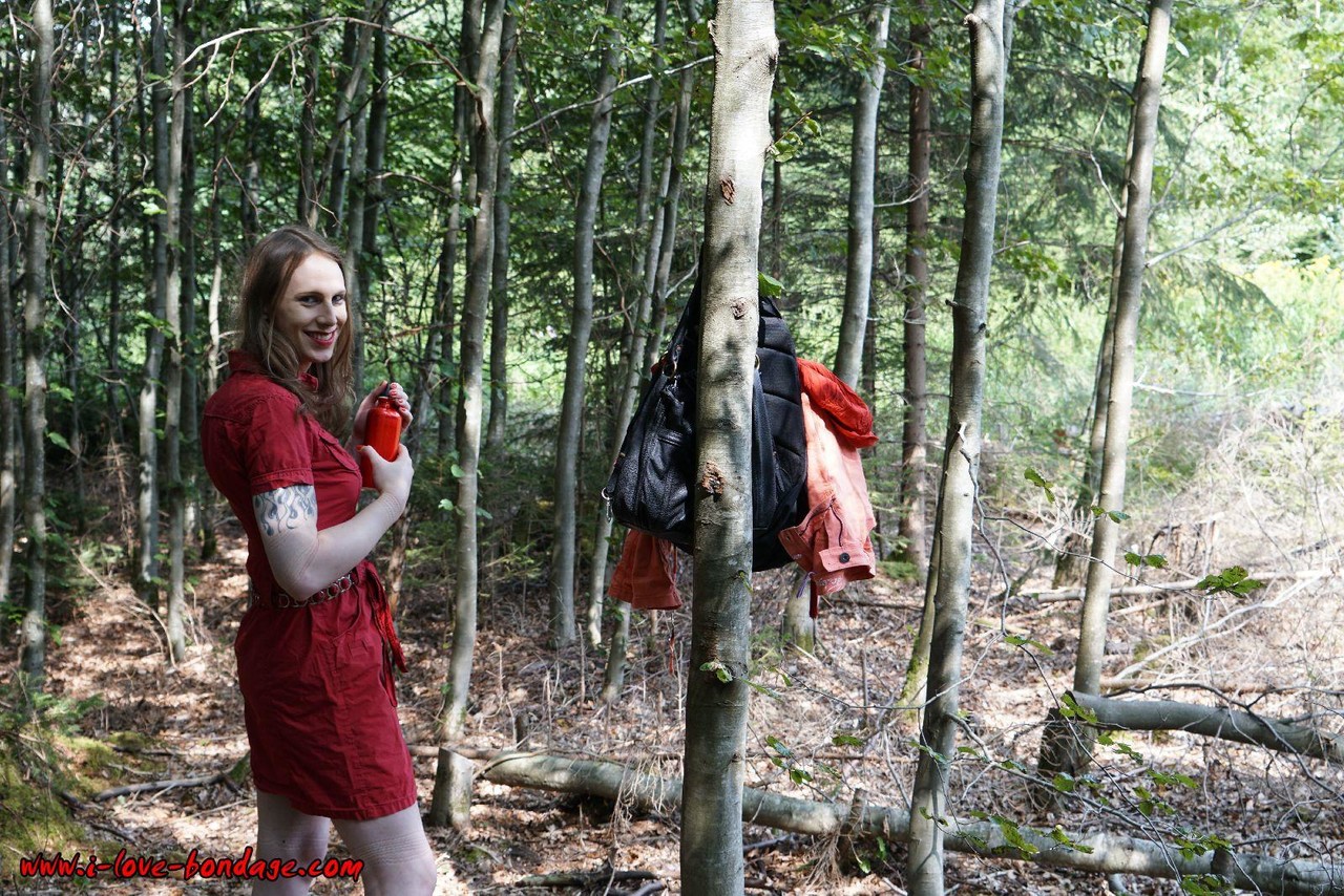 Clothed girl in canvas sneakers finds herself handcuffed to a tree in woods zdjęcie porno #427194863
