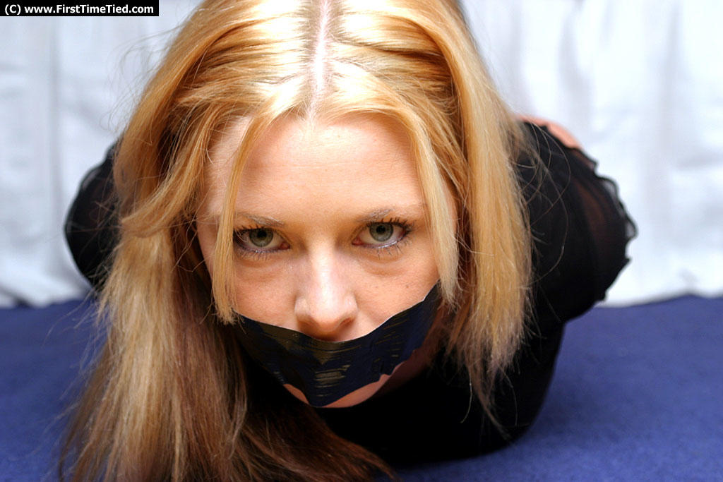 Natural blonde with blue eyes is left duct taped and hog tied in clothing porn photo #428572405