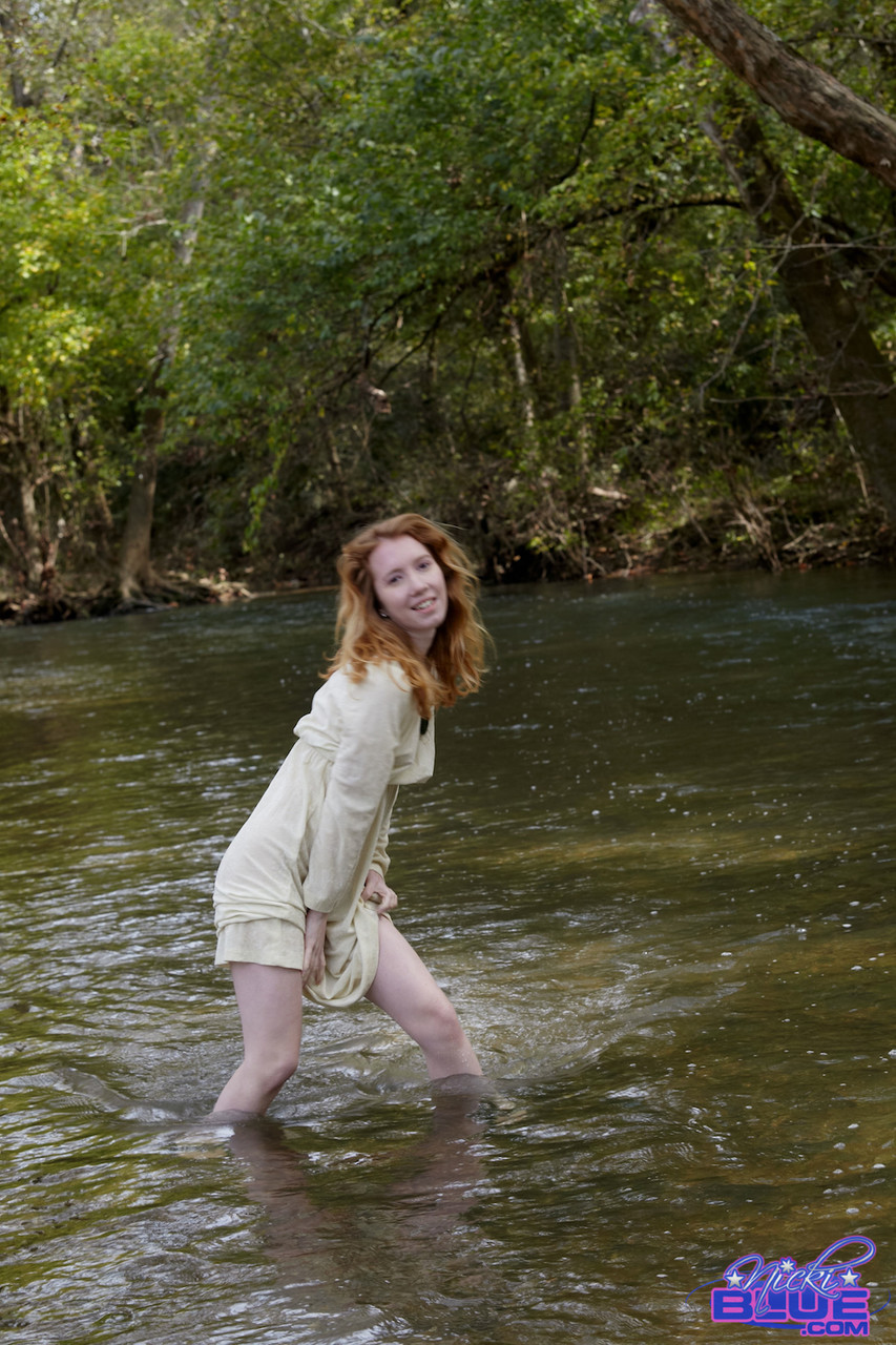 Natural redhead Nicki Blue shows some leg while wading into a shallow stream porn photo #425333623