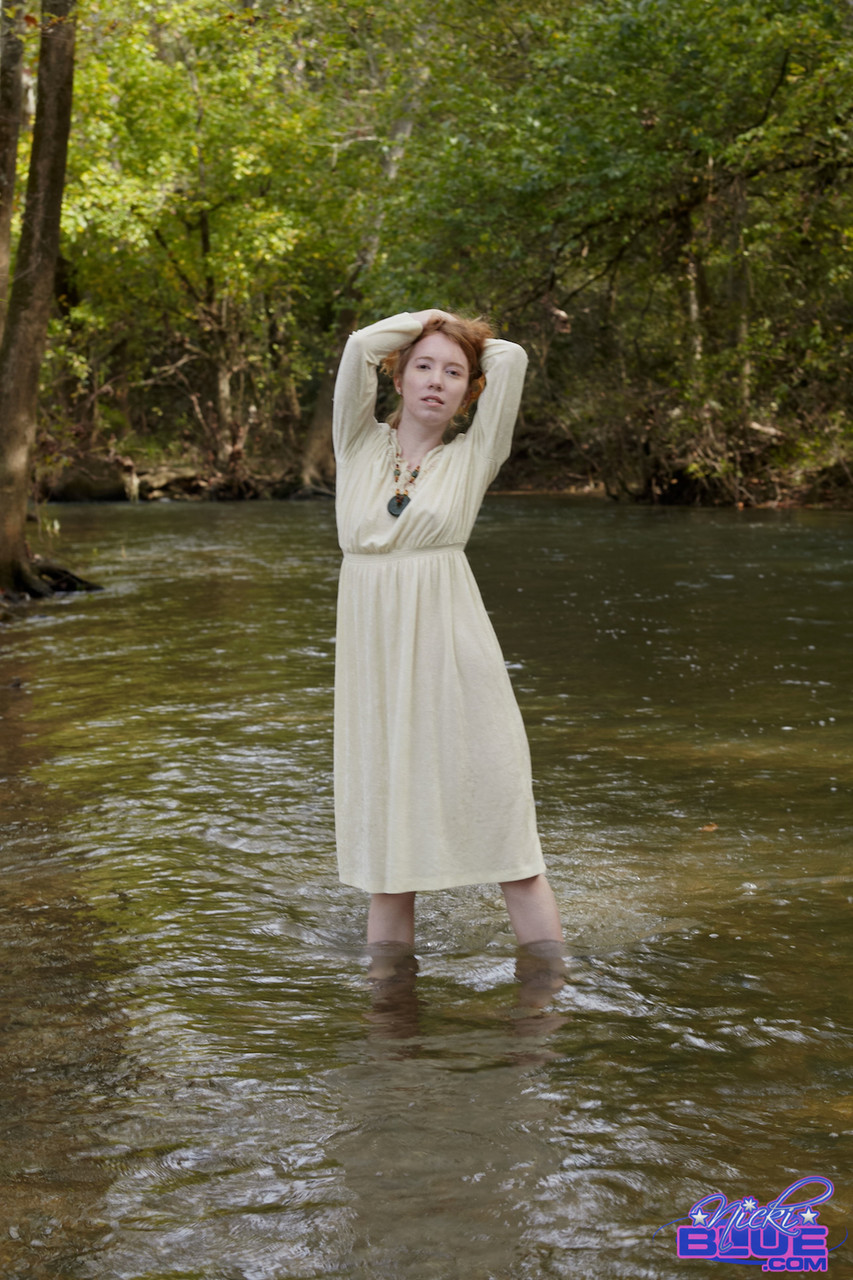 Natural redhead Nicki Blue shows some leg while wading into a shallow stream porn photo #425333625