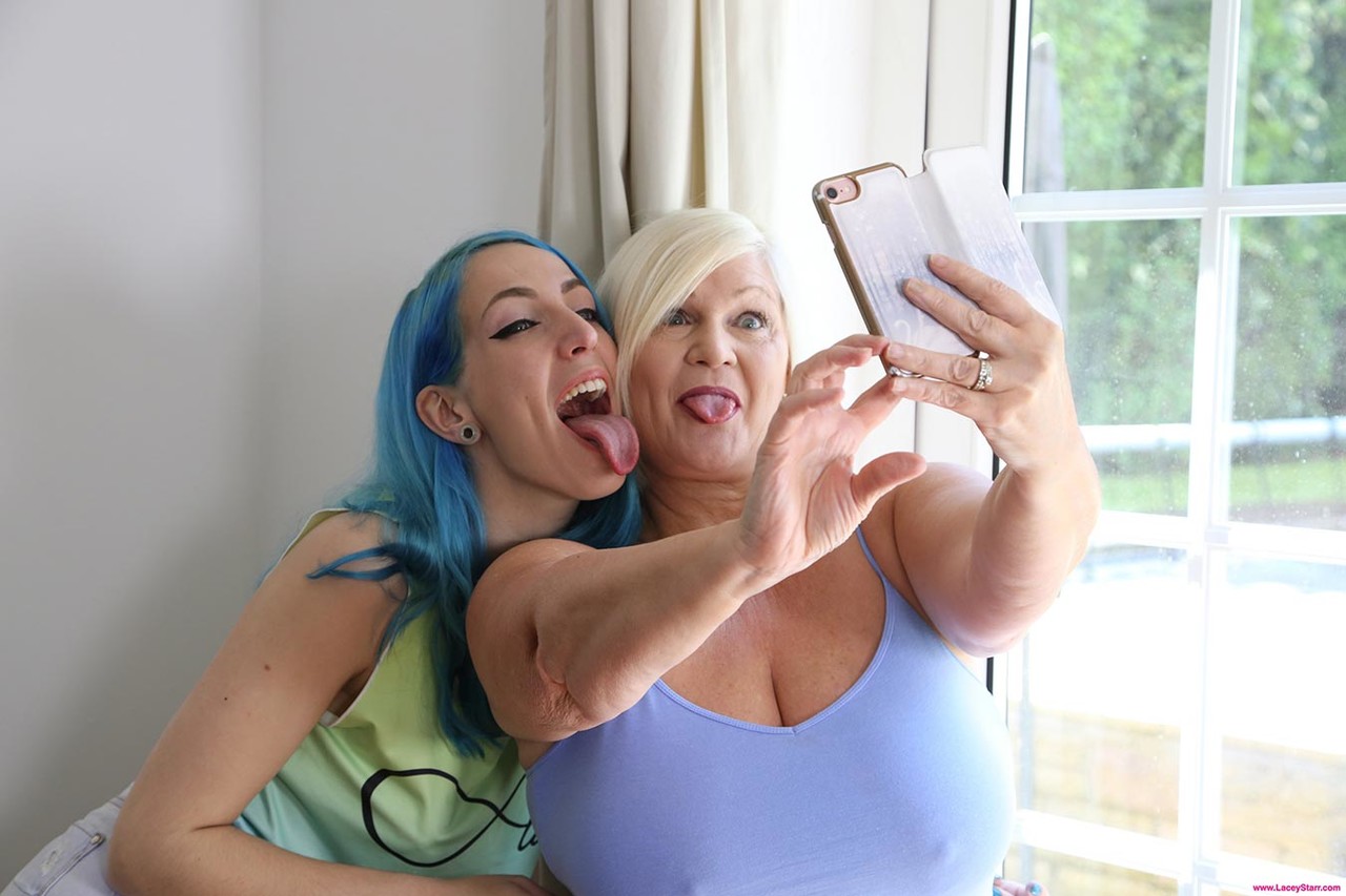 Lengthy lesbians Lacey Starr and Liz Rainbow take a selfie before having sex.