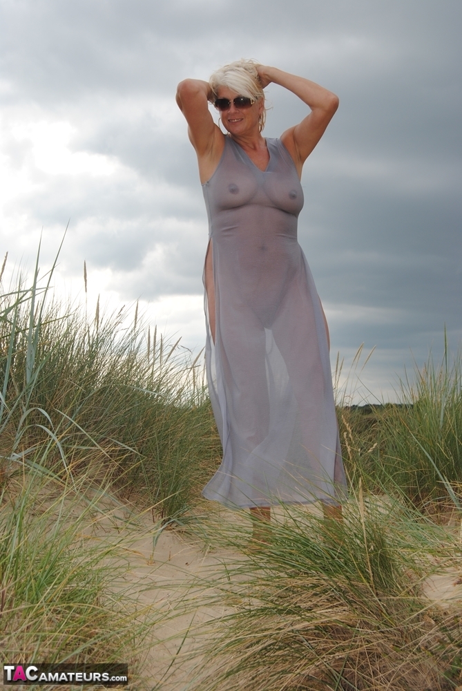 Mature platinum blonde Dimonty models at the beach in see through clothing porn photo #425316010
