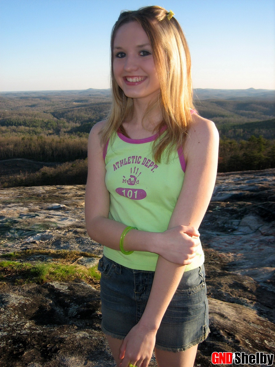 Perky teen Shelby flashes her perfect tits while on top of a mountain in a porn photo #426319517