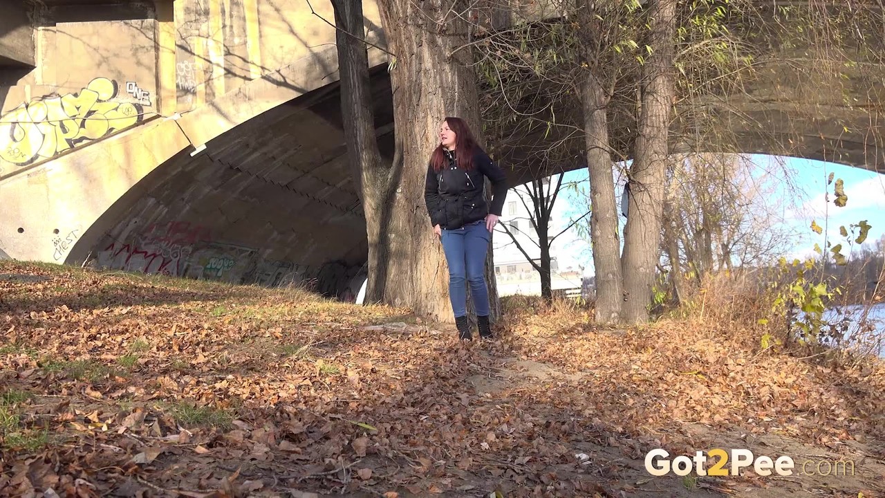 Solo girl Amanda Hill pulls down her jeans for a pee behind a tree in public порно фото #426335406