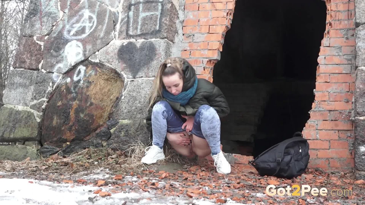 White girl pulls down her jeans for a badly needed pee on snow-covered ground porno fotoğrafı #426322478
