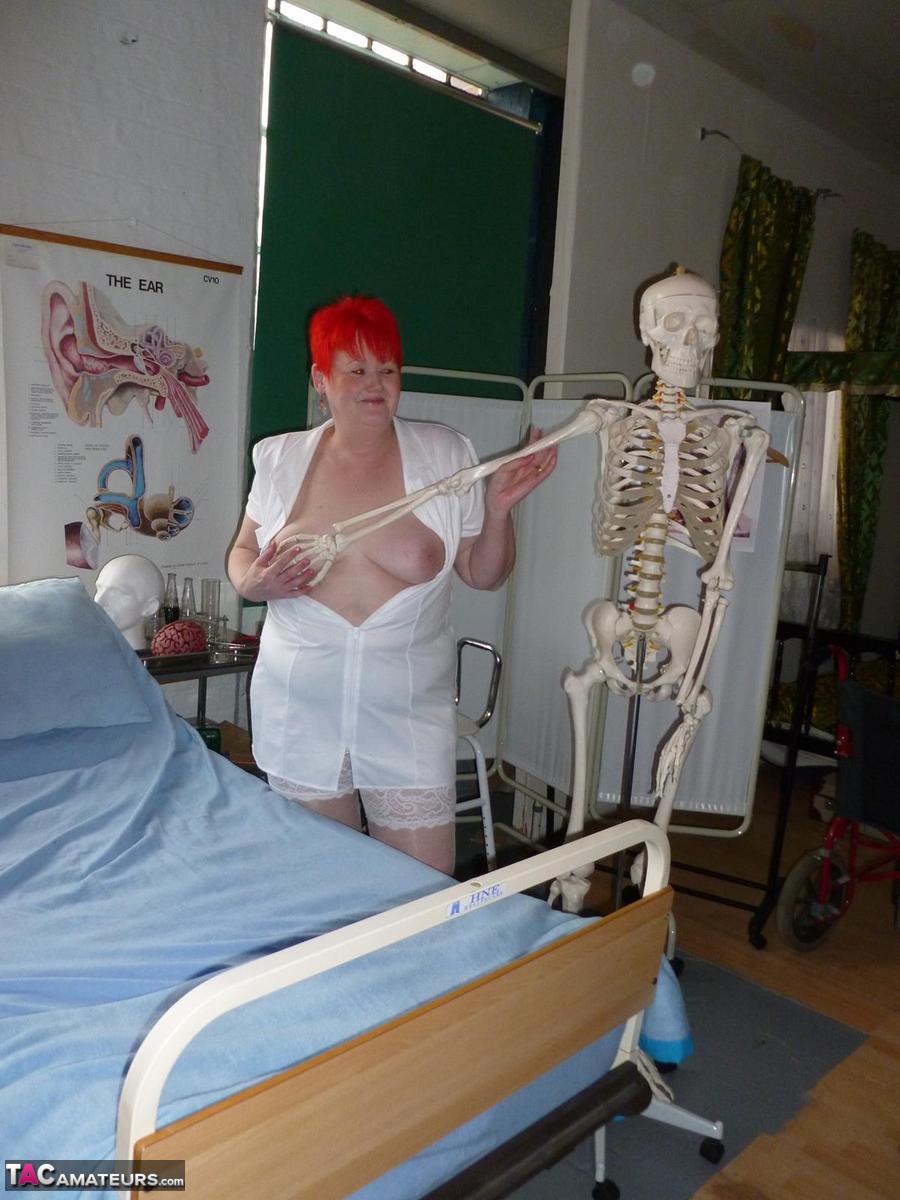 Redheaded nurse Valgasmic Exposed and a busty older lady play with a skeleton porn photo #423127390