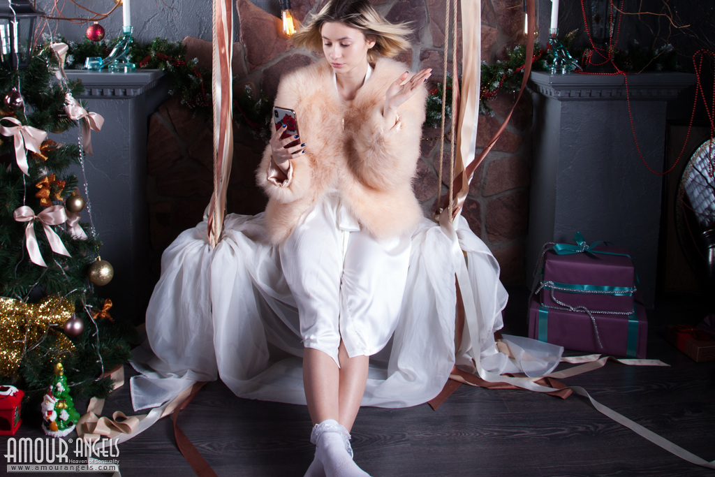 Young blonde Yulya gets naked near a Christmas tree in frilly white socks foto pornográfica #422894908