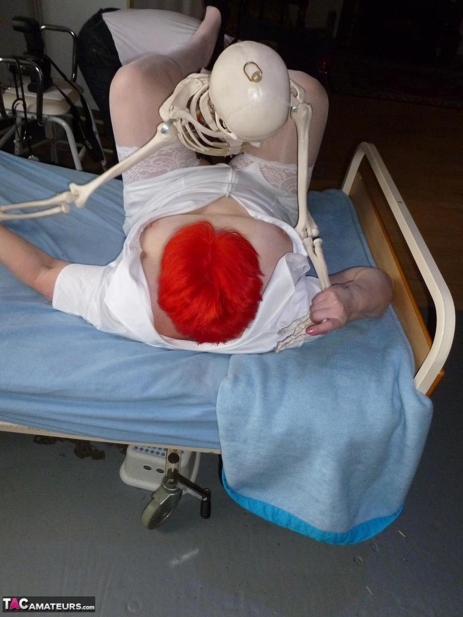 Older redhead nurse Valgasmic Exposed gets banged by a dildo wielding skeleton foto porno #425285433