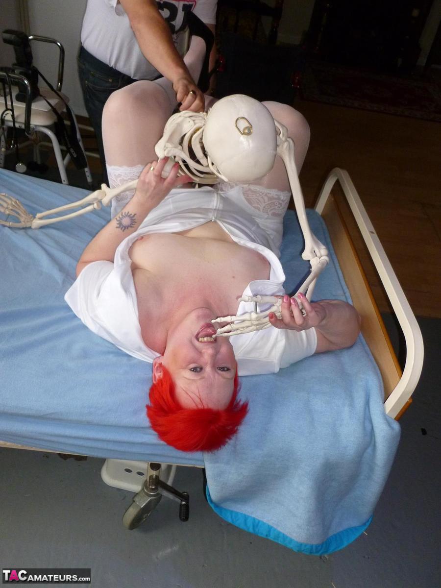 Older redhead nurse Valgasmic Exposed gets banged by a dildo wielding skeleton photo porno #425285435