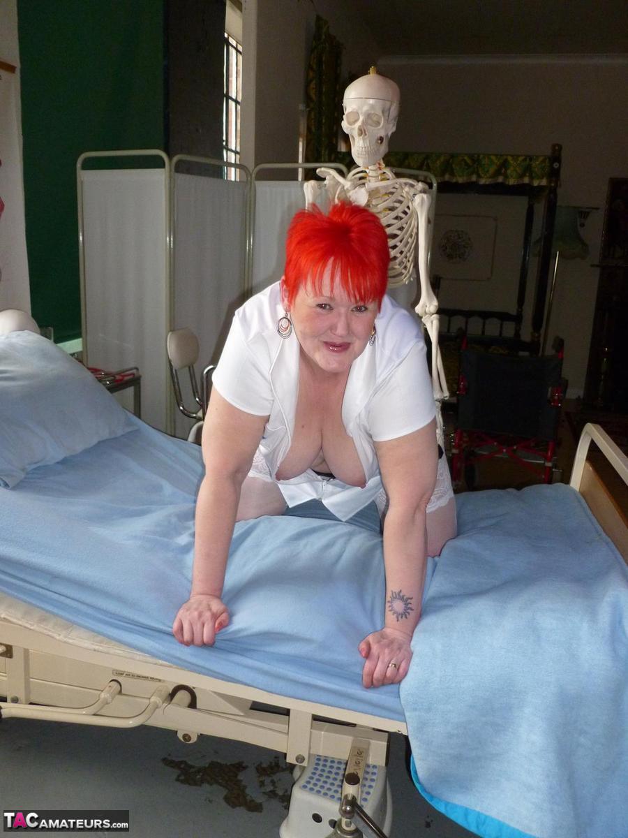 Older redhead nurse Valgasmic Exposed gets banged by a dildo wielding skeleton porno foto #425285439