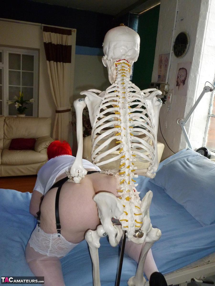 Older redhead nurse Valgasmic Exposed gets banged by a dildo wielding skeleton porn photo #424755967
