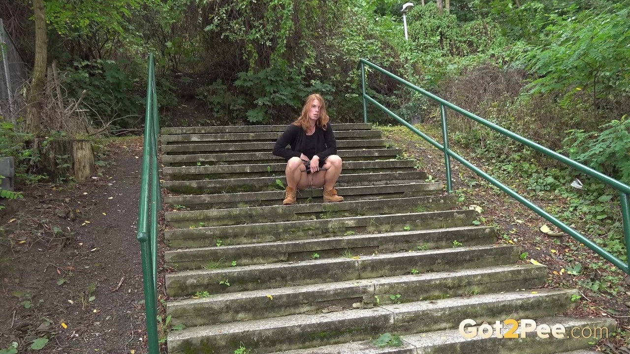 Natural redhead Chrissy Fox squats for a pee on a set of public steps foto porno #426820446