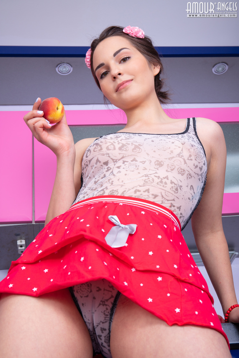 Cute teen Mi holds a couple of peaches while getting naked for the first time porn photo #426891590