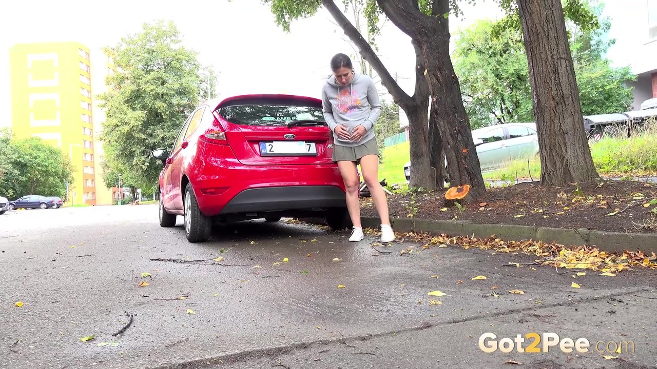 Short taken girl Lara Fox squats for a piss behind a vehicle on a road foto porno #425305533