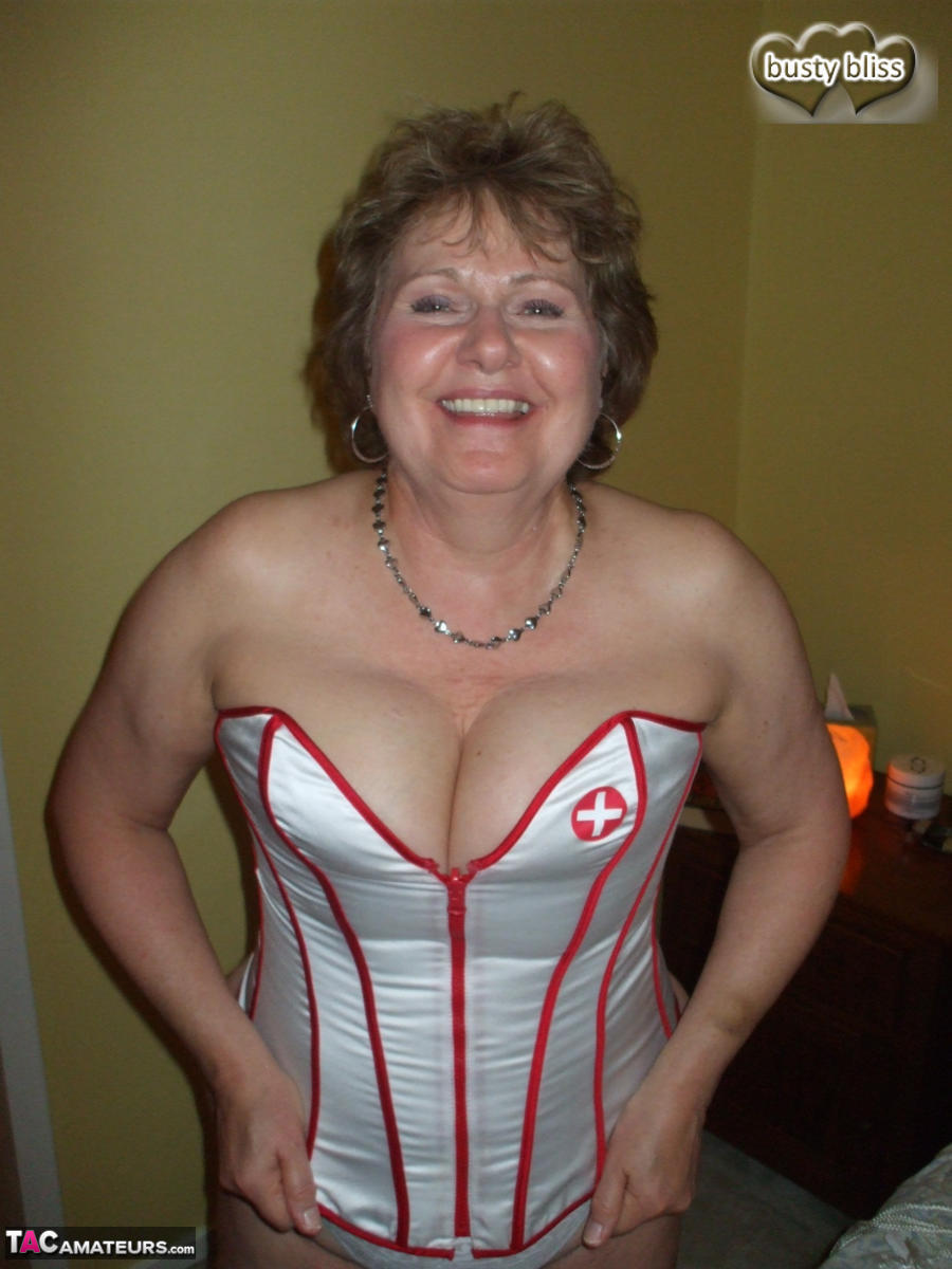 Mature woman Busty Bliss dons a collar before giving head in a corset porn photo #425268856