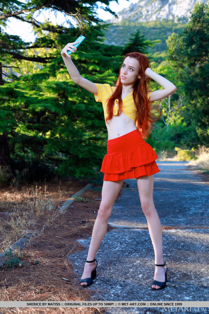 Young redhead Sherice gets totally naked after taking selfies on a forest path porn photo #424234415