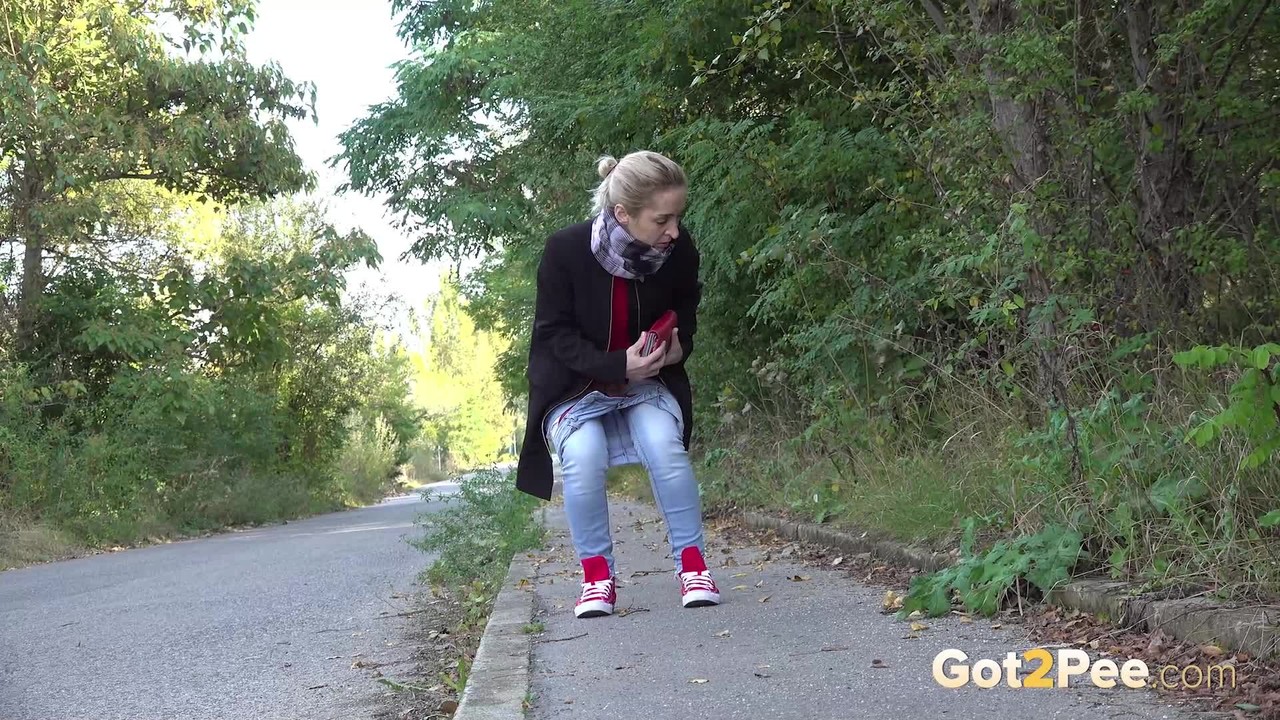 Pretty blonde Di Devi pulls down her jeans to pee on a public sidewalk porn photo #425166316