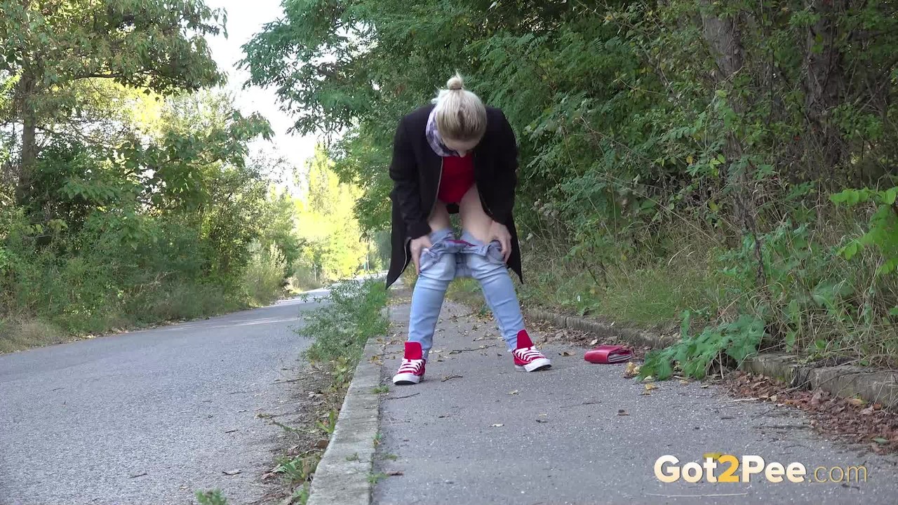 Pretty blonde Di Devi pulls down her jeans to pee on a public sidewalk photo porno #425166318