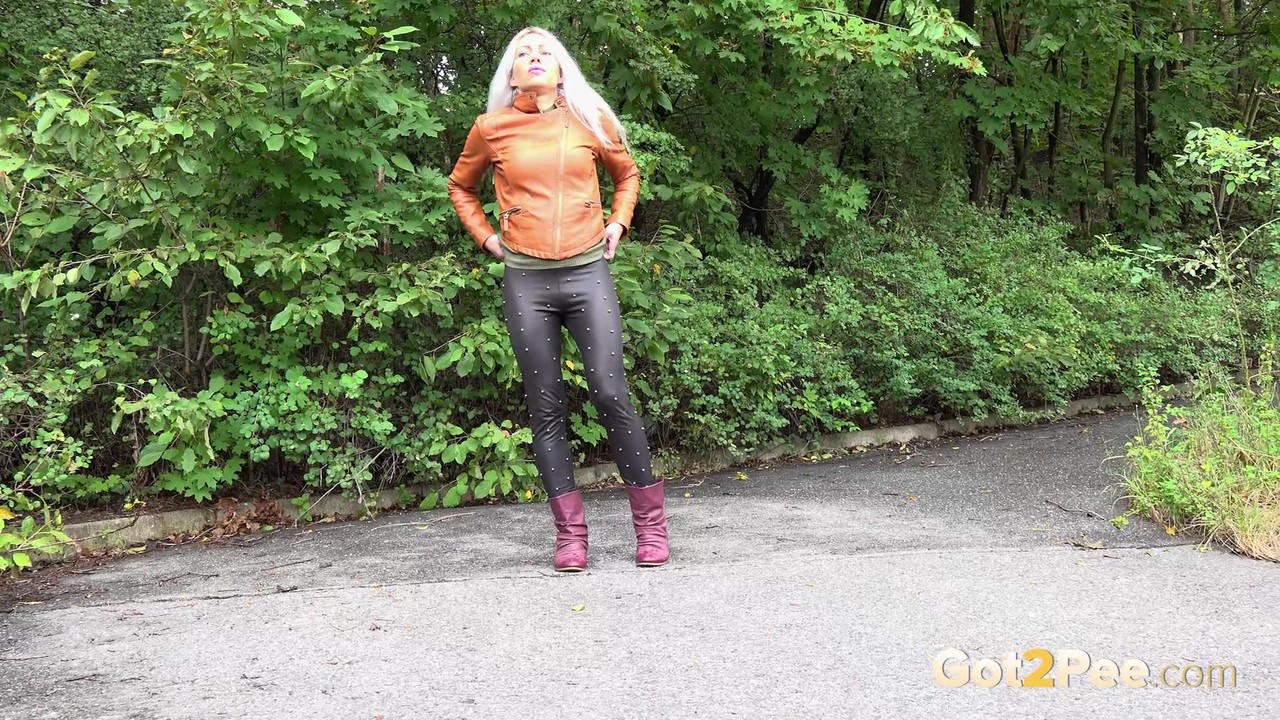 Platinum blonde squats for a piss on a paved road in the country foto porno #426456621