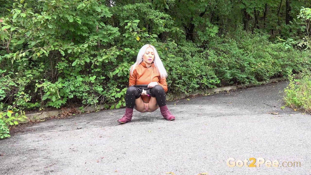 Platinum blonde squats for a piss on a paved road in the country porn photo #426456627