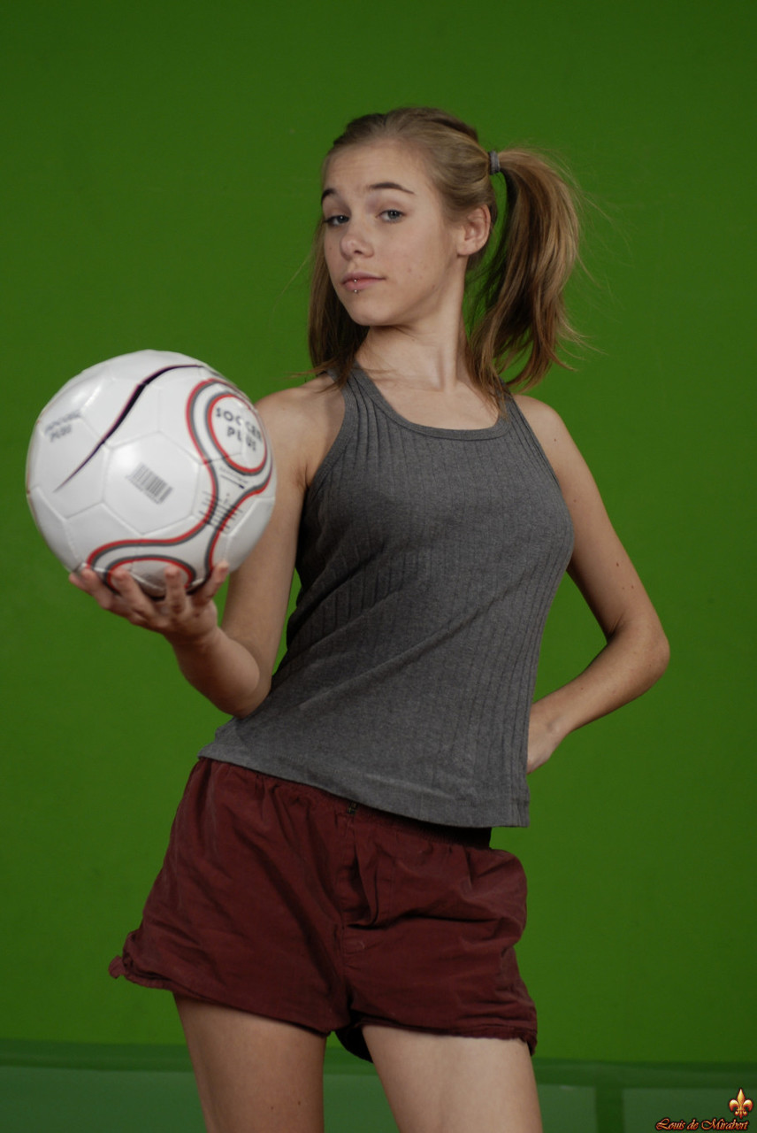 Petite girl Kelly exposes a breast while holding a soccer ball porn photo #426703885