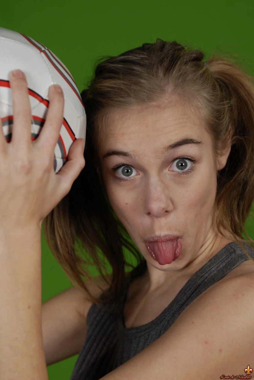 Petite girl Kelly exposes a breast while holding a soccer ball porn photo #426703989