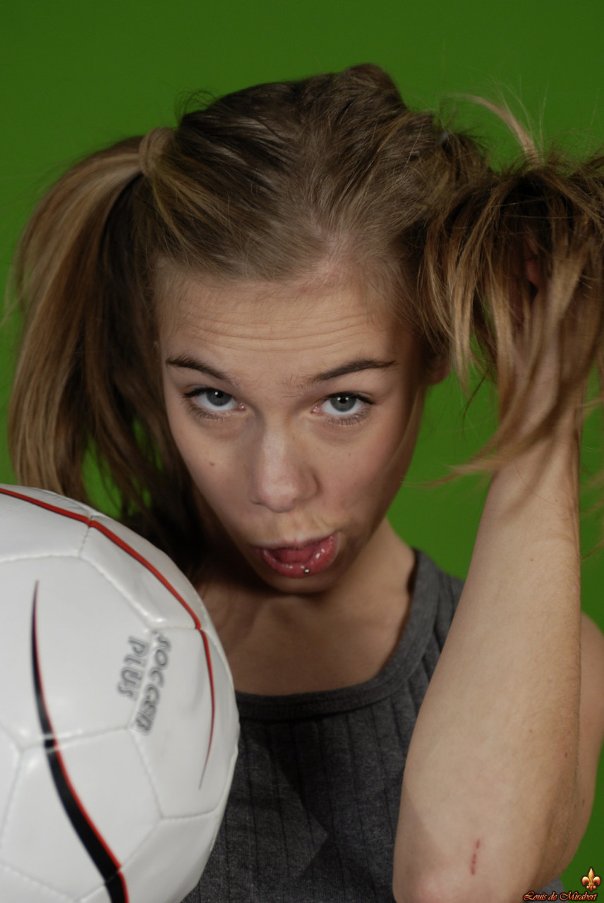 Petite girl Kelly exposes a breast while holding a soccer ball foto porno #426703994