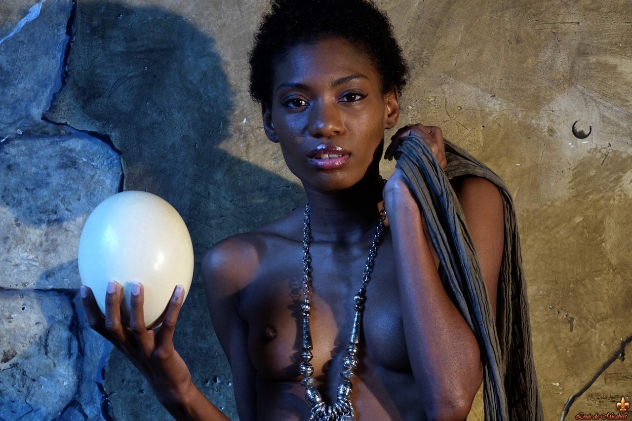 Dark Skinned Girl Jess Holds A Large Egg While Modeling Butt Naked