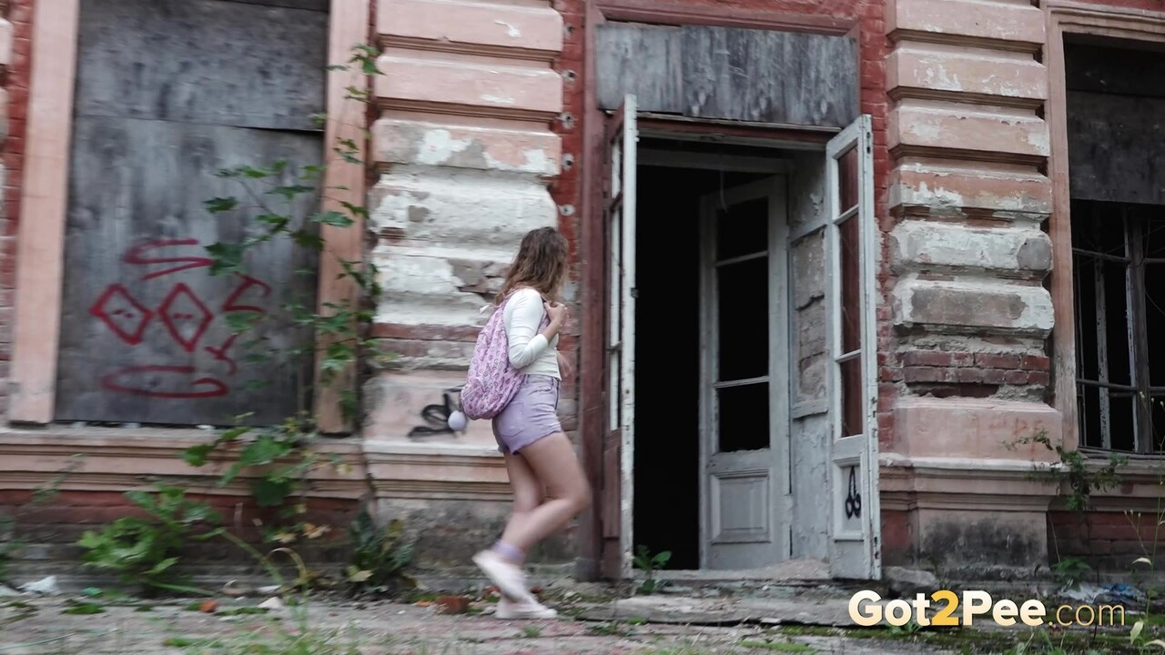 Caucasian girl Rita takes a badly needed pee out front of a derelict building porno fotoğrafı #428817213
