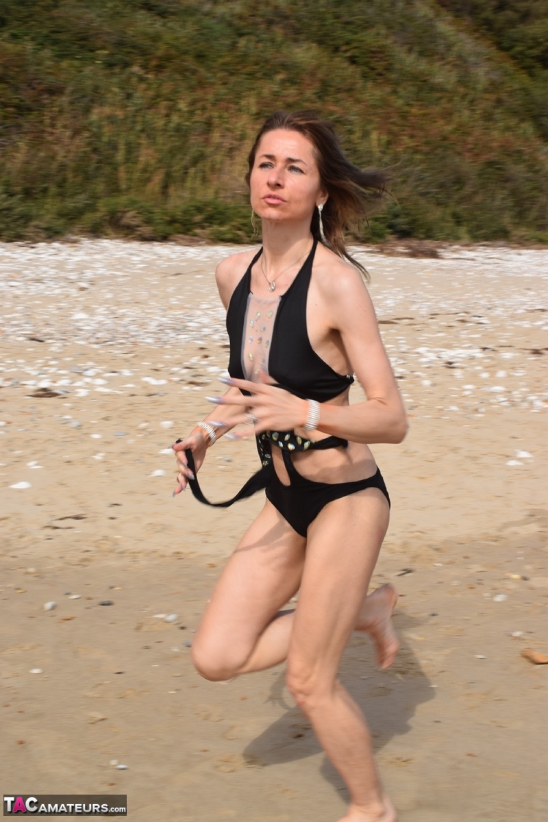 Slender female models a bathing suit while at a deserted beach foto porno #428703114