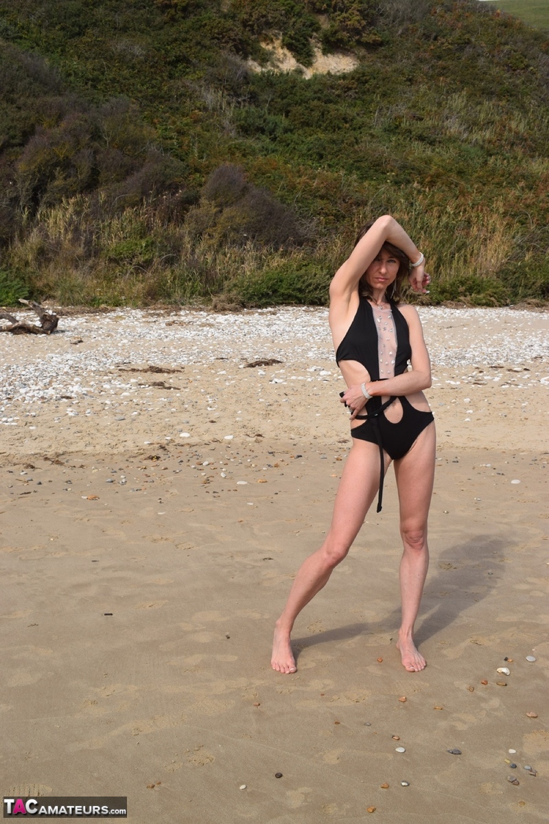 Slender female models a bathing suit while at a deserted beach porn photo #428703120