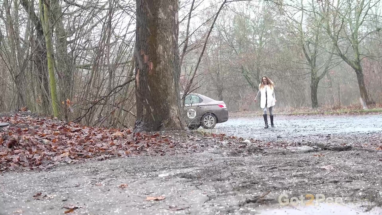 Solo girl Cynthia Vellons takes a piss in a gravel driveway on a wet day porn photo #424881843